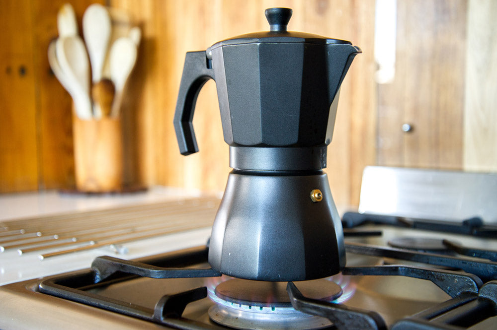 Moka pot brewing on gas stove